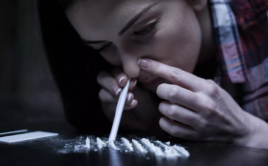 Junkie snorting cocaine lines
