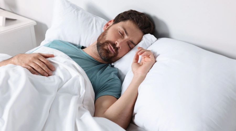 Man sleeping soundly in bed - Quality Sleep - Lifestyle Measures for Effective BPH Management