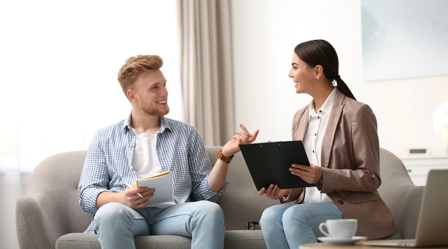 Image of Psychotherapy session with a smiling man talking to his psychologist - CPTSD Treatment
