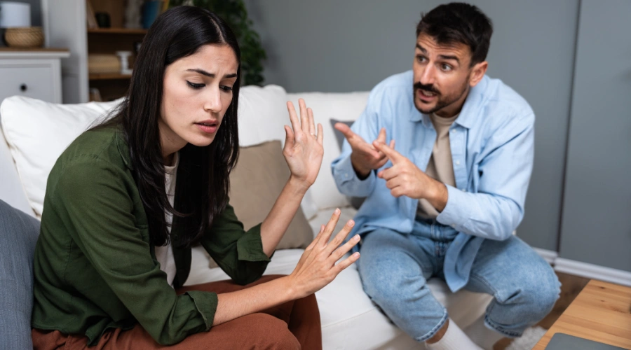 Image of upset wife while husband verbally abuses her