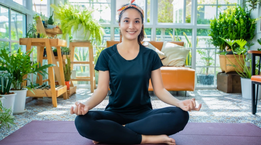Woman practicing yoga as part of self-care to rebuild confidence and self-esteem